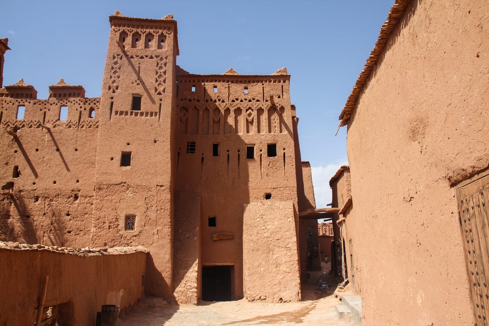 Carved mud-brick kasbah tower above a narrow alley, Ait Benhaddou