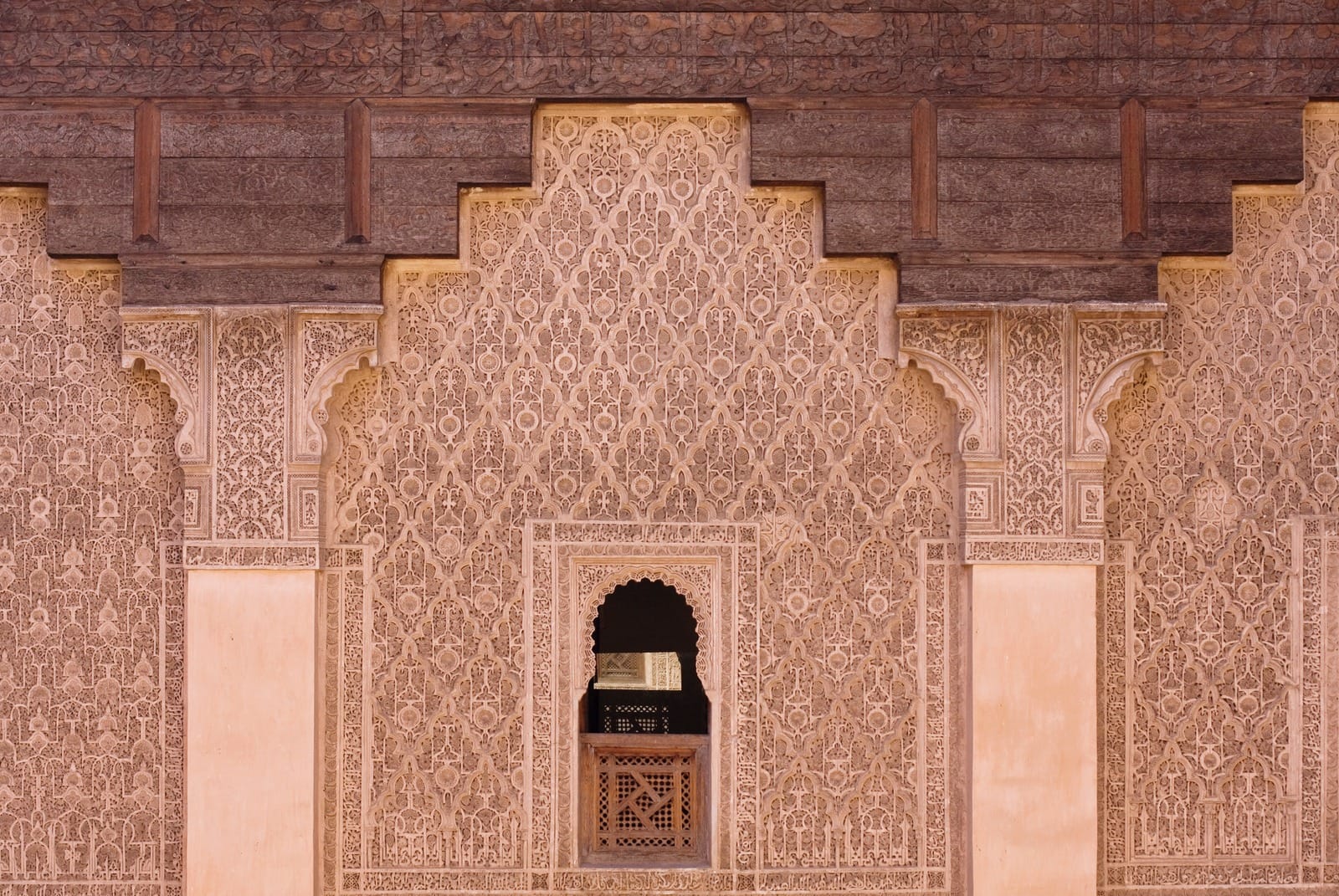 Student cell window with carved cedar screen set in stucco, Ben Youssef Madrasa