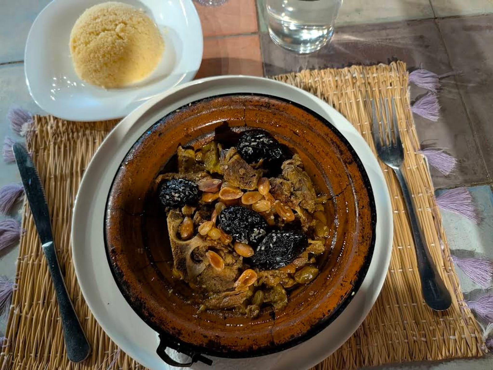 Lamb tagine with prunes and almonds served in a clay dish at Le Jardin, Marrakech