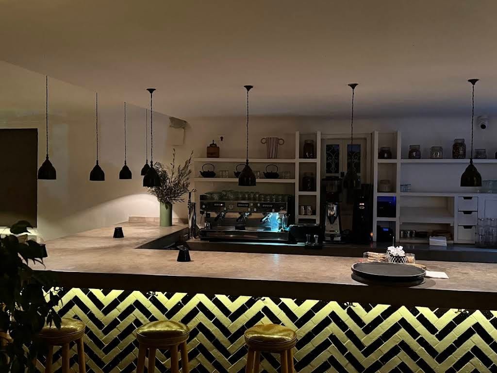 Zellige-tiled bar counter with pendant lights inside Nomad restaurant, Marrakech