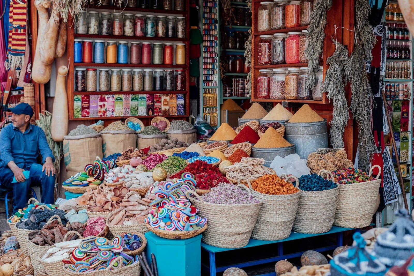 Herbalist stall with baskets of dried rosebuds and pigment cones, Marrakech souk